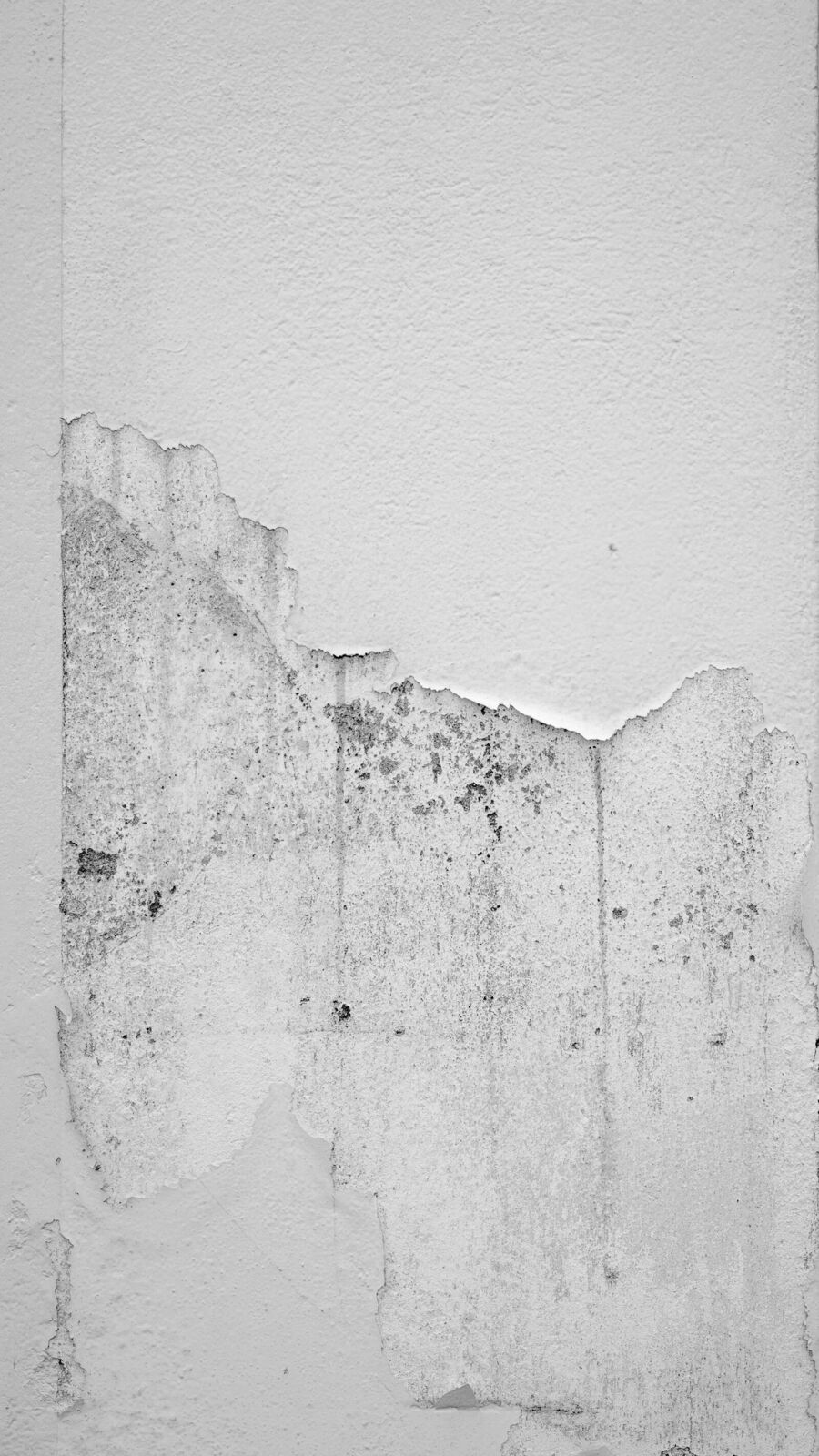Damaged drywall with a hole before repair
